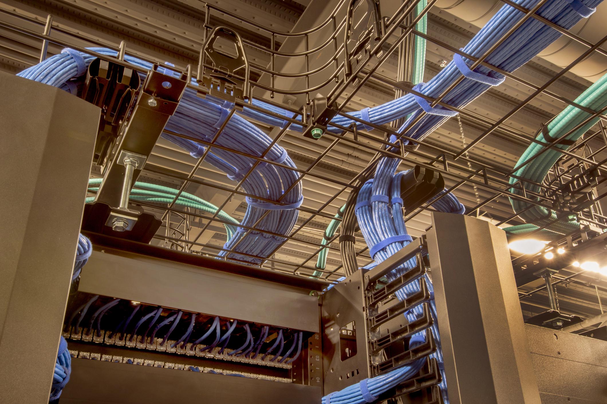Cable trays in a data center with cat 5 and optic fiber cables.